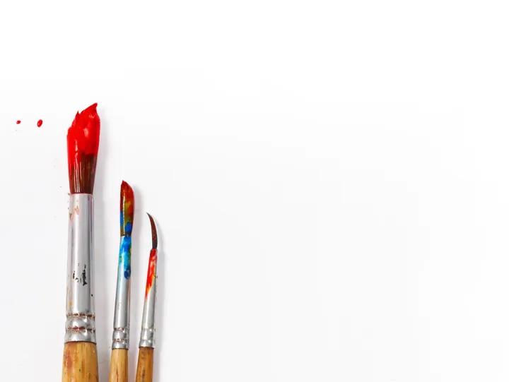 Three paint brushes on white background